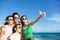 Happy family taking a selfie at the beach