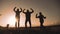 Happy family teamwork silhouette jumping for joy and happiness. concept success victory in business goal achievement. a