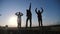 Happy family teamwork silhouette jumping for joy and happiness. concept success victory in business goal achievement. a