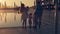 Happy family with three children admiring the sunset reflected in the surface of the pool