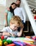 Happy family of three drawing together. Cheerful parents playing with son draw together at a home. Father mother and