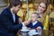 Happy family of three in Parisian cafe