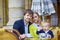 Happy family of three in Parisian cafe