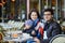 Happy family of three in Parisian outdoor cafe