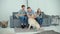 Happy Family of Three Playing with Dog at Home