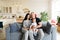 Happy family of three portrait, young parents mother and father and little boy in arms look at camera posing together