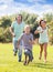 Happy family of three running on grass