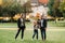 A happy family of three runs through the grass in Austria`s old town.A family walks through a small town in Austria.Europe.Velden