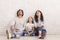 Happy family of three sitting on floor and looking upwards