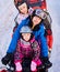 Happy family of three spending great time together in the mountains in winter riding quad bike