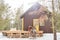 Happy family of three in winterwear having chat on wooden porch by cottage