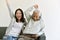 Happy family time, Smiling asian daughter and elderly father enjoy watching movie from tablet computer together.