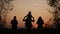 happy family tourists go hiking in park sunset silhouette. adventure travel concept. teamwork. happy family a tourists