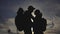 Happy family tourists silhouette at sunset hug kissing. teamwork travel concept. man and woman couple with lifestyle