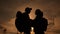 Happy family tourists silhouette at sunset hug kissing. teamwork travel lifestyle concept. man and woman couple with