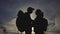 Happy family tourists silhouette at sunset lifestyle hug kissing. teamwork travel concept. man and woman couple with