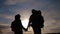 Happy family tourists walking holding hand lifestyle silhouette at sunset. hikers teamwork travel concept. man and woman