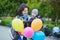 Happy family of two with bunch of colorful balloons in Paris