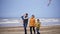 Happy family with two children enjoying a weekend with a kite on the beach