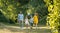 Happy family with two children holding hands during recreational walk