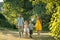 Happy family with two children holding hands during recreational walk