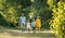 Happy family with two children holding hands during recreational walk