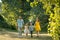 Happy family with two children holding hands during recreational walk