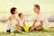 Happy family with two children playing at beach