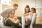 Happy family with two daughters playing at home.