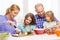 Happy family with two kids making dinner at home