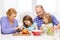 Happy family with two kids making dinner at home