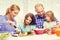 Happy family with two kids making dinner at home