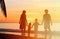 Happy family with two kids on sunset beach