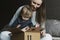 Happy family unwrapping big cardboard box delivered to their house. Online shopping and delivery from international retailers