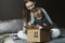 Happy family unwrapping big cardboard box delivered to their house. Online shopping and delivery from international retailers