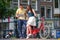 Happy family vacation on bikes in old streets in Amsterdam