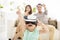 Happy family with virtual reality headset in living room