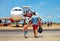 Happy family walking for boarding on plane in airport, summer vacation