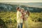 A Happy family walking history. mother and baby hugging in a meadow yellow flowers on nature in summer