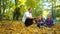 Happy family walks in the autumn Park with a Beagle dog. Children pet dog