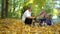 Happy family walks in the autumn Park with a Beagle dog. Children pet dog