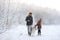 The happy family walks with a dog huskies