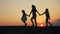 Happy family walks at sunset in the park silhouette.mom and two daughters hold hands outdoors. kid dream concept. happy