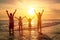 Happy family watching the sunset on the beach