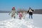 Happy family in winter, having fun and playing with snow outdoors on holiday weekend