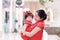 happy family young Chinese mother has fun with baby in China traditional cheongsam