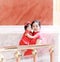 happy family young Chinese mother has fun with baby in China traditional cheongsam