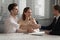 Happy family young couple shaking hands with financial advisor.