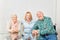 Happy family with young woman and seniors couple at home