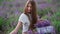 Happy farm girl with flowers basket, lavender field.